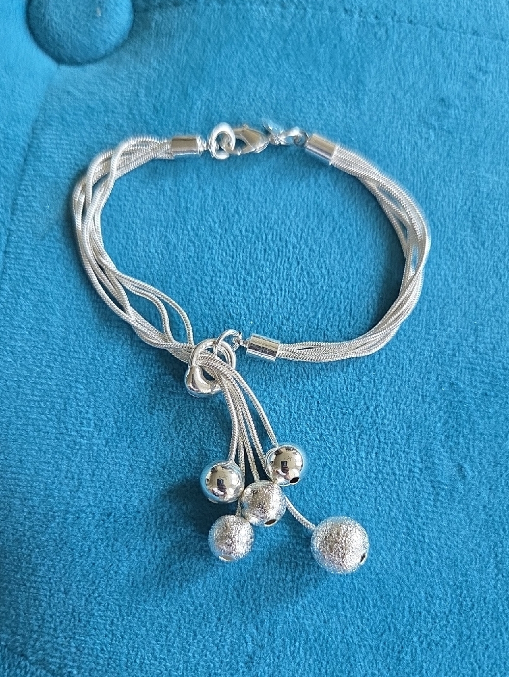 Elegant Silver Multi-Strand Knot Bracelet with Dangling Beads